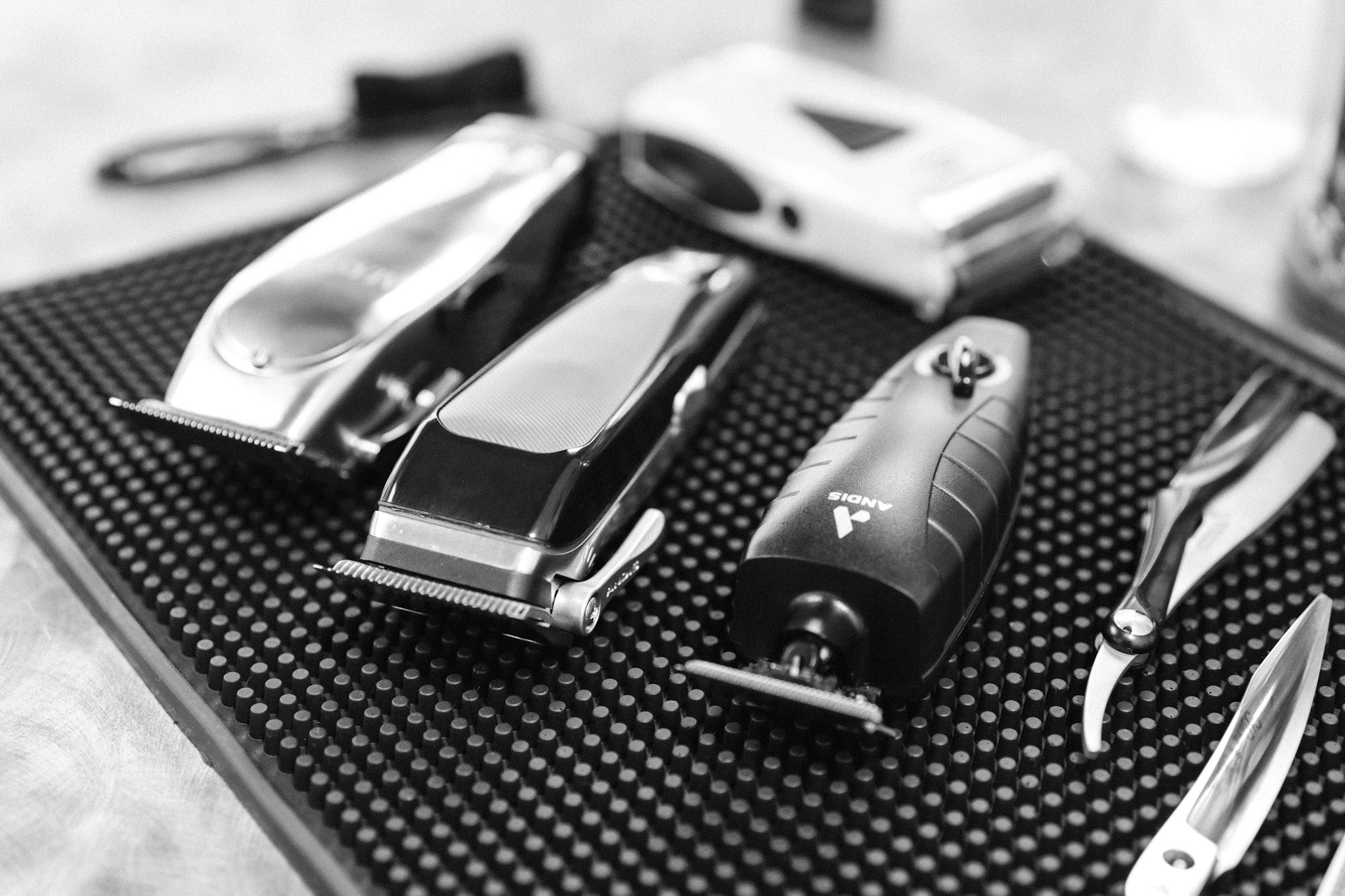 Professional barber tools including clippers and scissors on workstation at The Bureau Barbershop, Salt Lake City’s premier barbershop